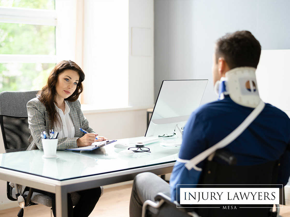 An injured man being advised by a professional personal injury attorney in Mesa, AZ
