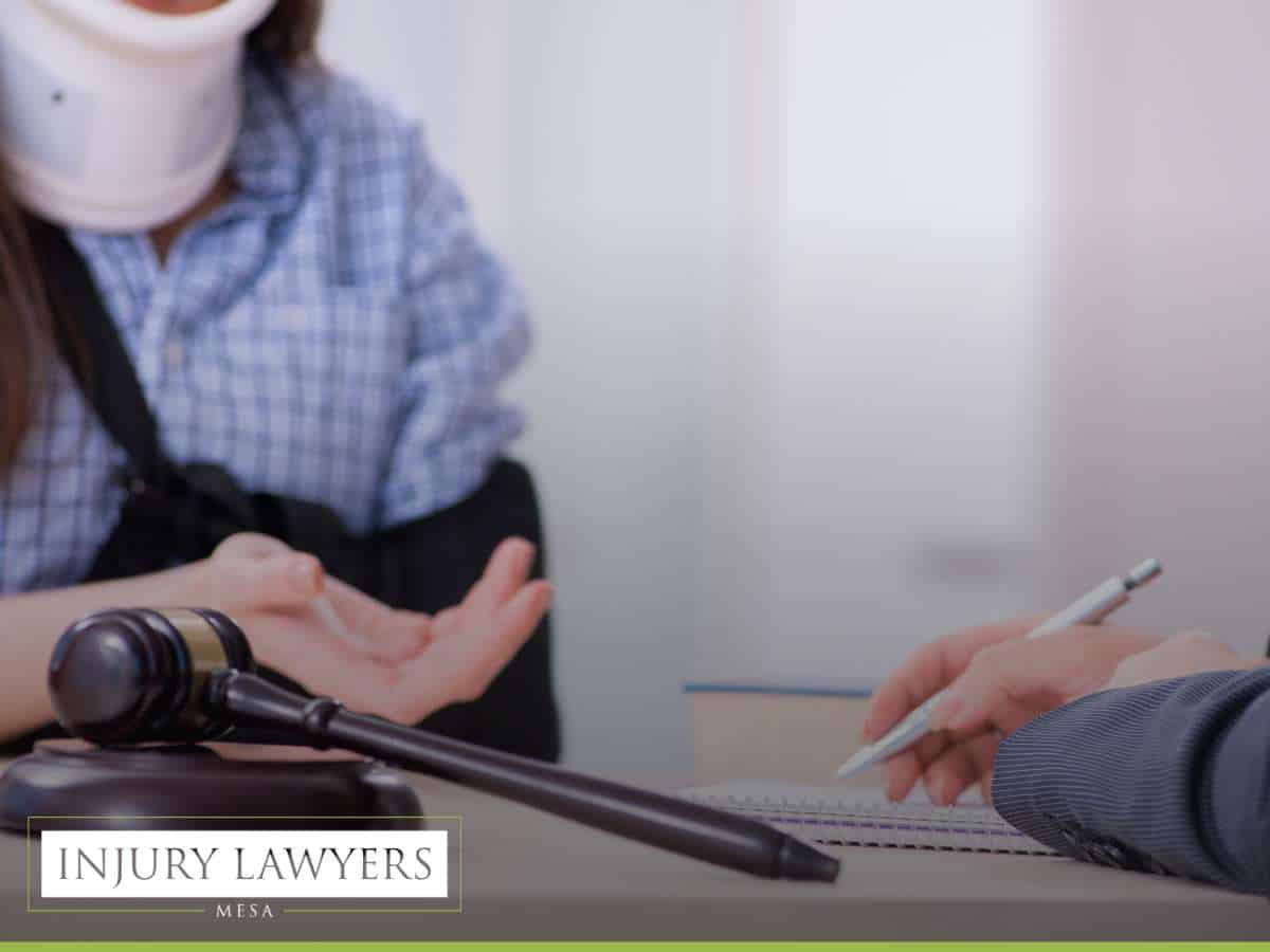 A person with a neck brace discussing with an injury lawyer in Mesa, representing a consultation following a rental car accident
