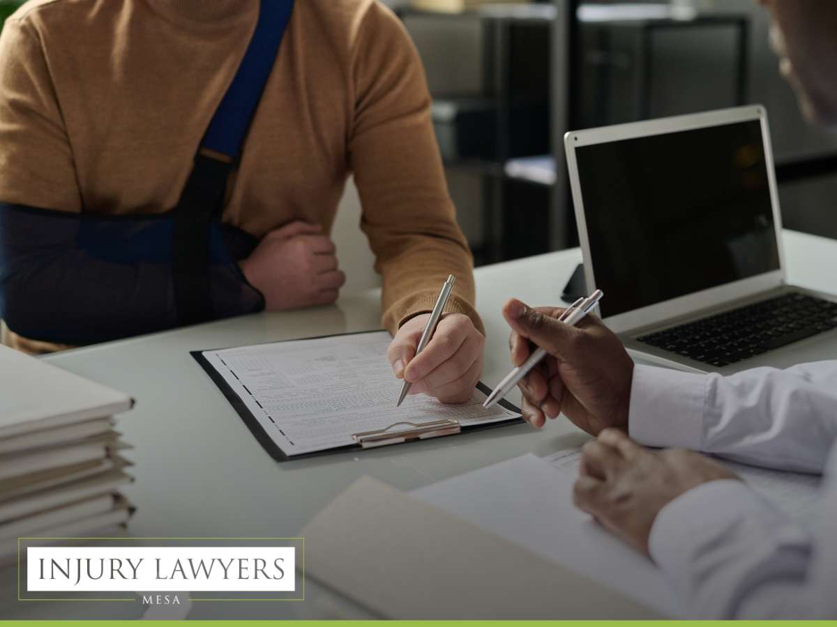 Lawyer assisting an injured client after car crashes, reviewing documents.